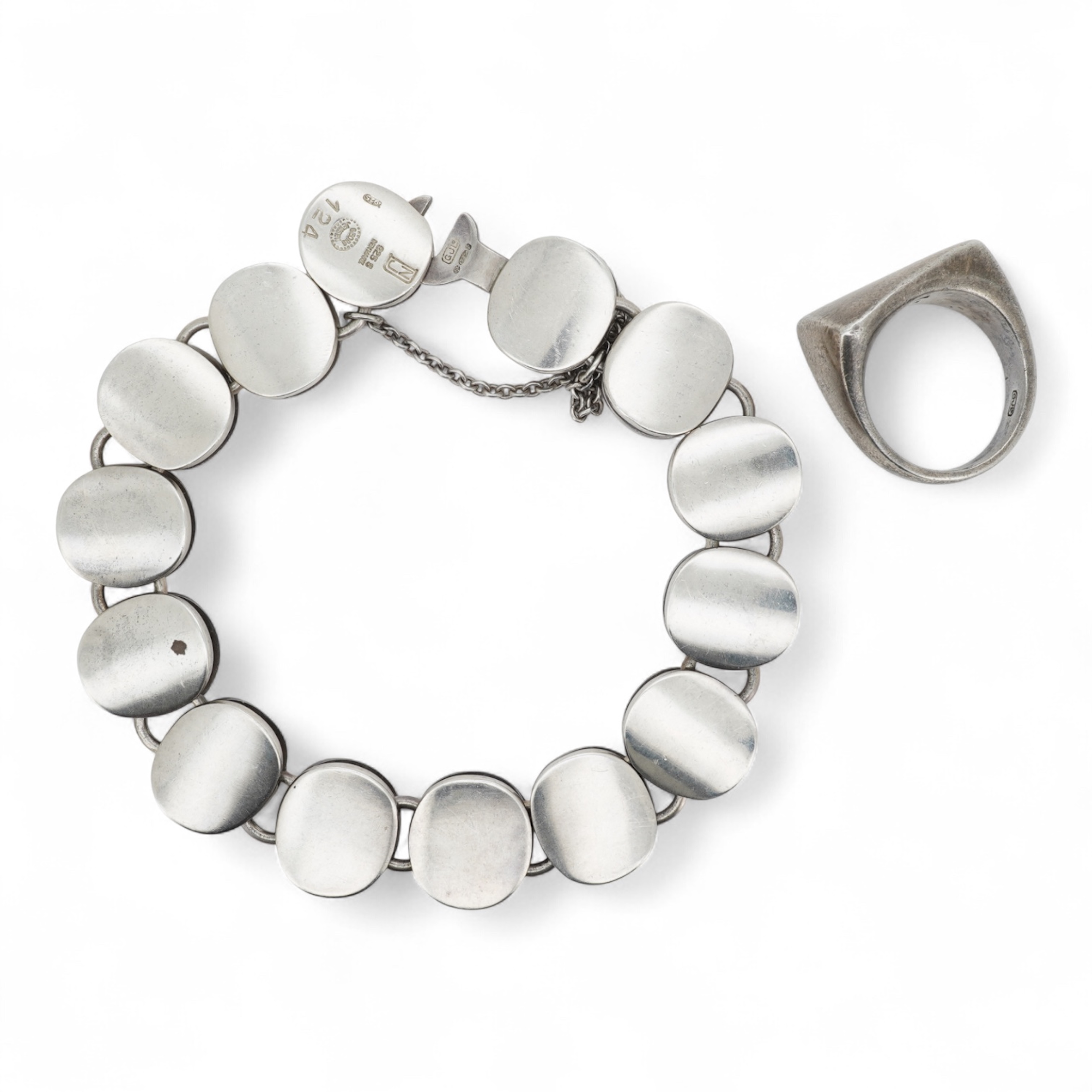 Nanna Ditzel for Georg Jensen, a silver bracelet, circa 1972, and a Georg Jensen ring, circa 1968, the bracelet composed of polished oval links with a concealed hoop clasp, length approximately 17cm, signed Georg Jensen,